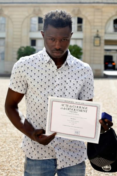 0_1527549765674_Gassama-with-a-certificate-of-courage-given-him-by-the-Paris-Police.jpg